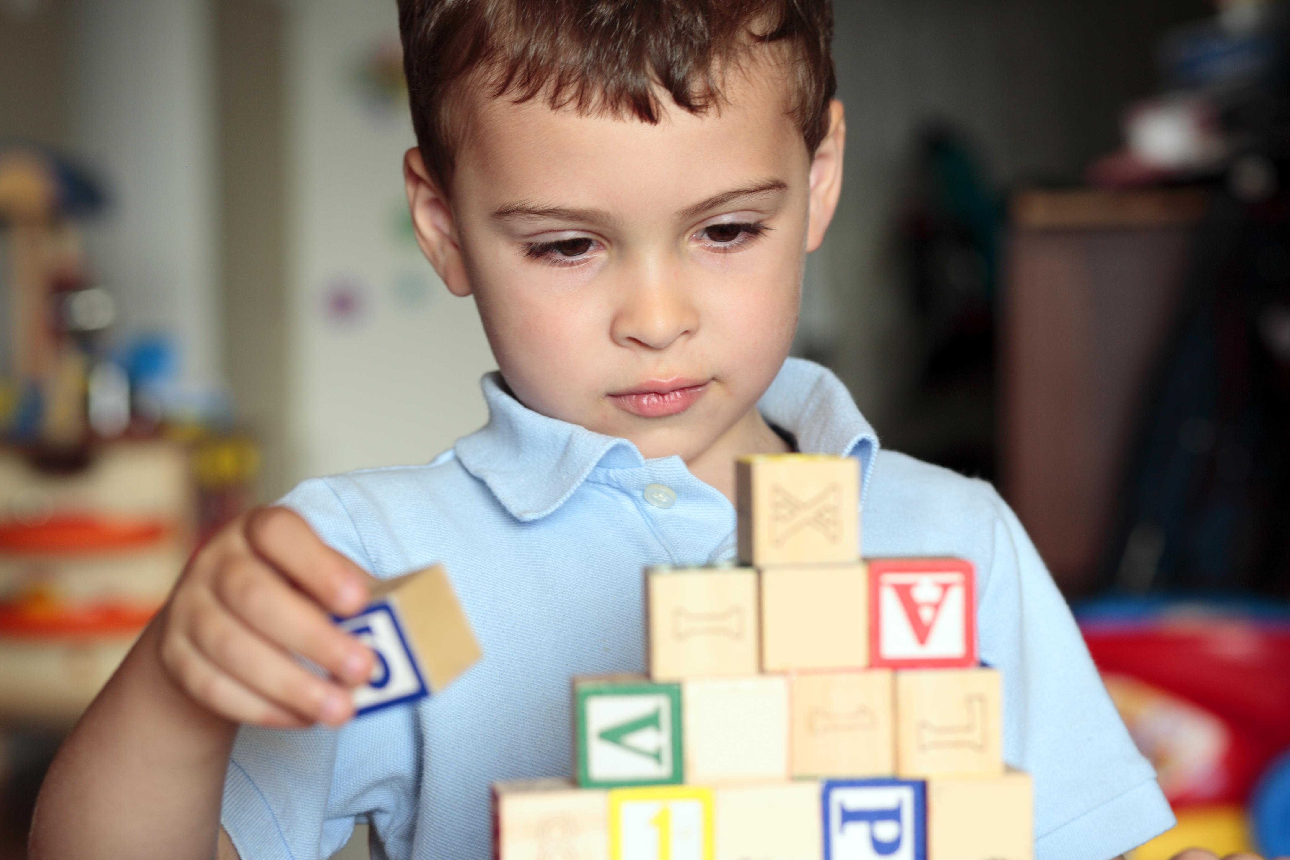Autistic boy building with blocks