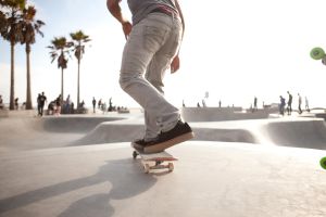 Skater about to skate down a ramp at a skatepark