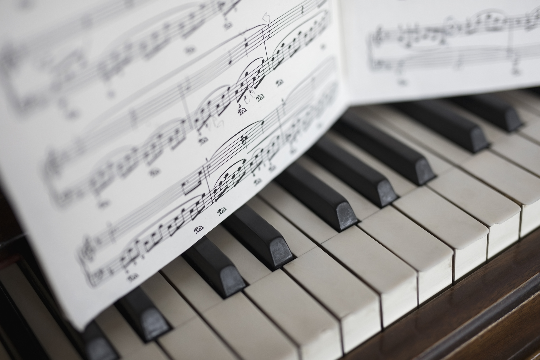 Close up sheet music over piano keys