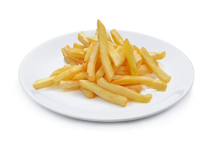 Close-Up Of French Fries In Plate Against White Background
