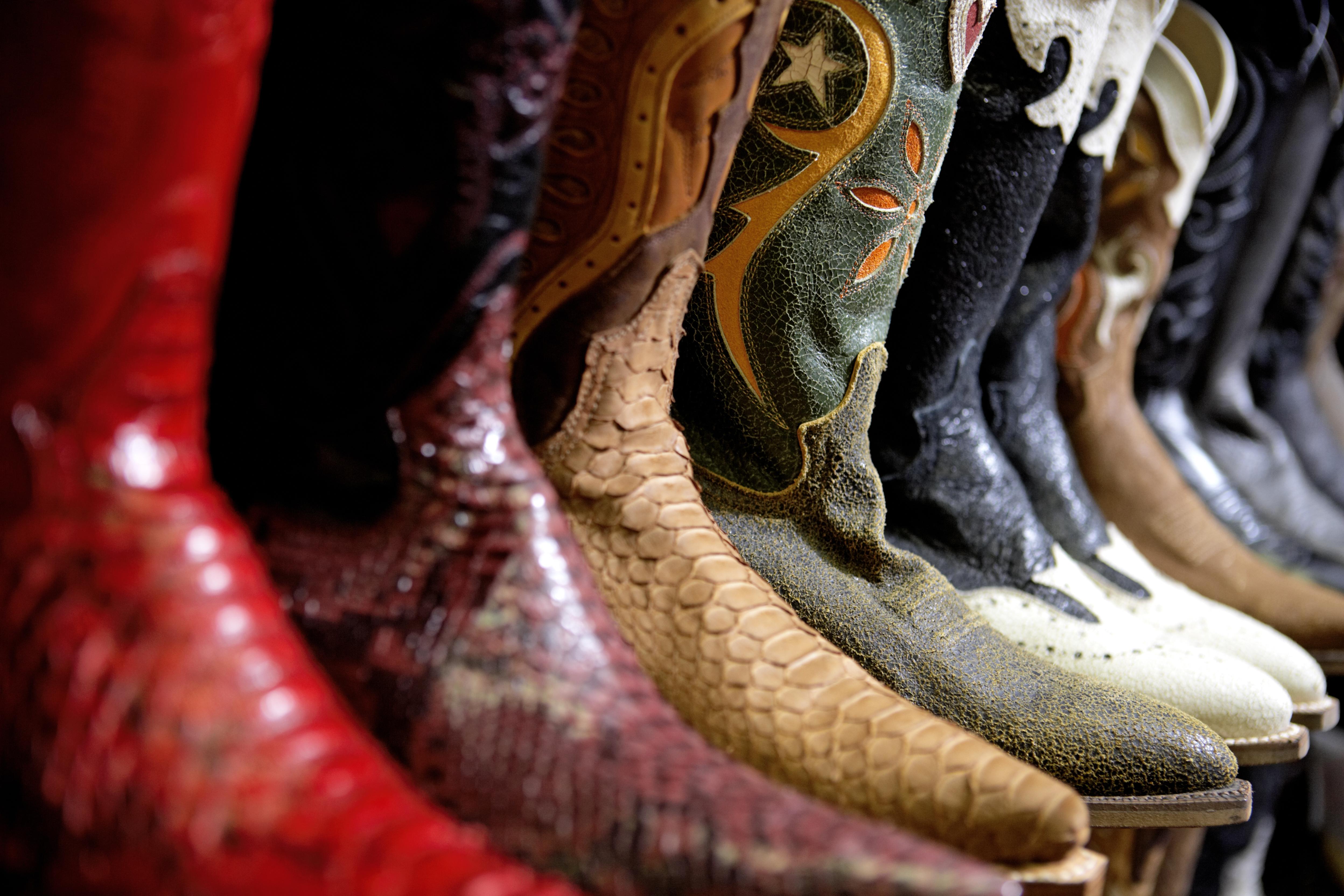Row of cowboy boots in shoe store, full frame